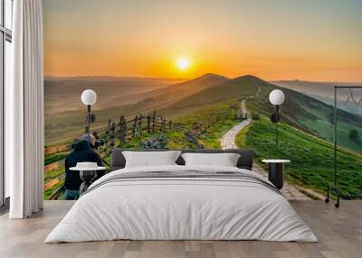 Landscape photographer at Mam Tor hill  in Peak District taking picture at sunrise Wall mural