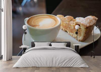 Piece of an apple pie and cup of coffee espresso on wooden table. Shallow focus Wall mural