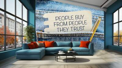 PEOPLE BUY FROM PEOPLE THEY TRUST text on paper peeking out of pocket and pen Wall mural