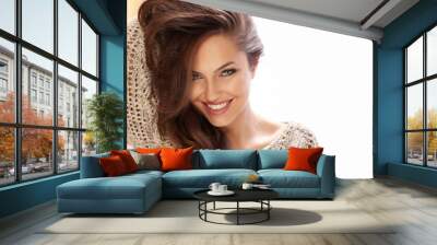 Cheerful young beauty sitting on the bright couch and relaxing Wall mural