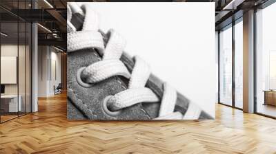 Brand new gray sneakers footwear with white shoelace isolated on empty copy space studio background. Wall mural