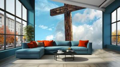 Rustic wooden cross standing alone on a windswept Wall mural