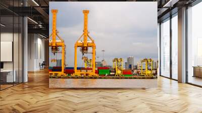 Shipping industrial trade port. Crane bridge and import export container at shipping port harbor. Logistics industrial and transportation business concept Wall mural