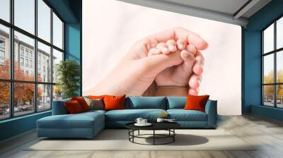 Baby hand holding finger mom on vintage tone. (Selected focus) Wall mural