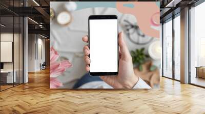 Hand holding smartphone with white screen mockup Wall mural