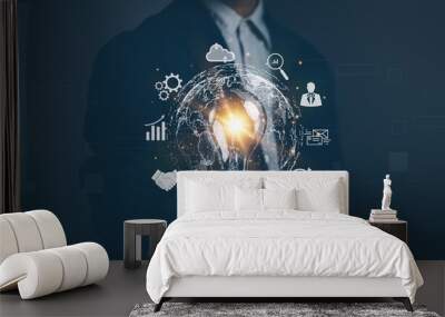 Businessman holds light bulb showing global internet connection application technology. Concept of digital marketing ,digital link technology, big data ,Finance and Banking Wall mural