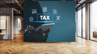 concept of government taxes and calculation of tax returns Personal income tax. man using tablet Fill out income taxes online using internet technology on application with State tax payment form Wall mural