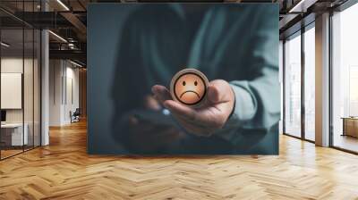 man holding round stick with a sad face icon Expressing extreme dissatisfaction, concept of poor experiences or poor service and customers are not satisfied Low rating in customer feedback evaluation Wall mural