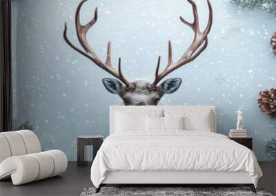 A serene winter scene featuring a deer head surrounded by festive holiday decorations, snow, and pine elements. Wall mural