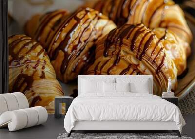 Delicious chocolate drizzled croissant on a plate, perfect for breakfast or dessert. Indulge in a flaky pastry delight. Wall mural