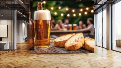 Enjoying beer and bread at a summer gathering with warm lights in the background. Wall mural