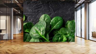 Fresh green spinach leaves on a dark textured background. Perfect for healthy eating and vegetarian food concepts. Wall mural