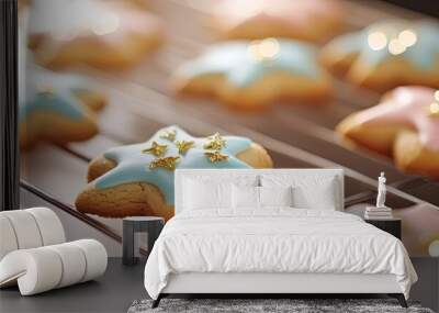 Freshly baked star-shaped cookies, decorated with blue and pink icing, ready to delight your taste buds and festive gatherings. Wall mural