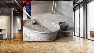 Construction workers mix cement in large tanks Wall mural