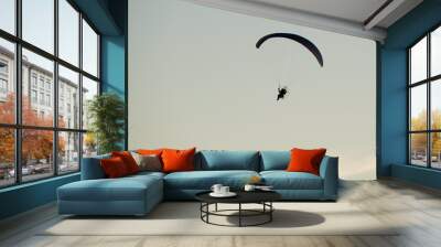 Paramotor, flying on a beautiful sky at sunset              Wall mural