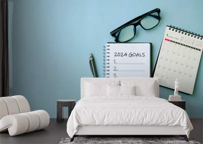 2024 New Year goal, plan, and action concepts. 2024 goals Text on Note Pad with calendar, glasses on the table.New Year's resolutions plan.Happy New Year theme, top view, copy space. Wall mural