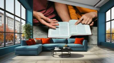 Christian couples read and study the Bible at home or in Sunday school. Sunday readings, spirituality, and religion Concept. Wall mural