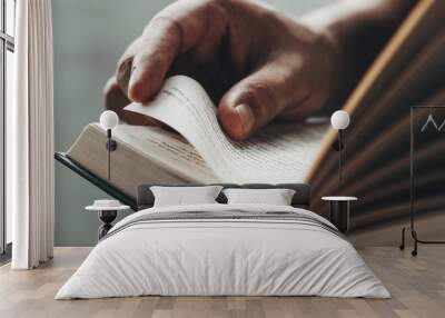 Close up man hands.Young man opening and reading a book, Wall mural