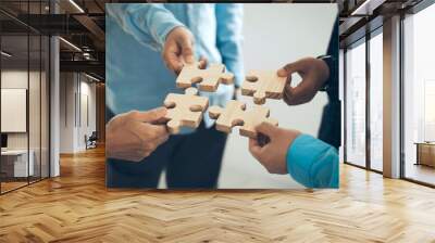 Concept of teamwork and partnership. Business hands join puzzle pieces in the office. business people putting the Jigsaw team together. Charity, volunteer. Unity, team business. business idea.CSR.ESG Wall mural