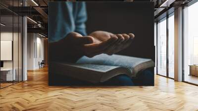 Hands open palm up in prayer on a Holy Bible in church concept for faith, spirituality, and religion, a woman praying on holy bible in the morning. woman hand with Bible praying. prayer bible Wall mural