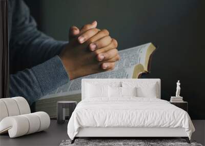 Man praying hands clasped together on  Bible. Christian life crisis prayer to god. Man Pray for god blessing to wishing have a better life.  believe in goodness. spirituality and religion.prayer bible Wall mural