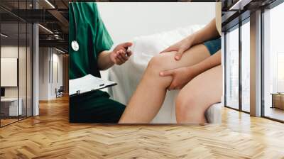 The patient is consulting a therapist and explaining with injured leg or knee after the accident and explain to her the diagnosis of the problem in clinic, Sport exercise injuries. Wall mural