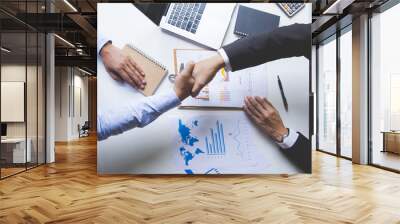 Top view close up Business people shaking hands in the office.finishing up a meeting Wall mural