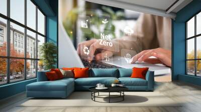 women hand using laptop for working technology and business Net zero and carbon neutral concept.NET ZERO icons and symbols save the eco world and reduce pollution. greenhouse gas emissions target. Wall mural