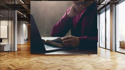 Young Man reading Holy bible books and online study with a window light at church.Concept of Christian online technology.Online live church for Sunday service.Bible study.Sunday readings Wall mural