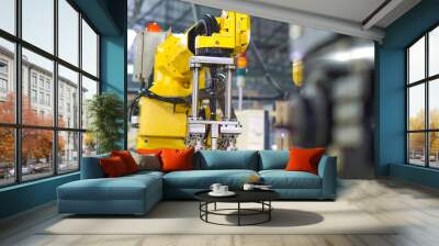 Blurred of factory robot arm with control box and copy space. Use for robot factory artwork concept Wall mural