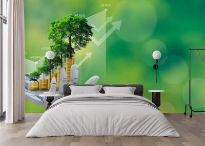 Ai robot hand holds a stack of coins with a tree growing on top against a green nature background. The concept of the blend of technology, finance, and environmental sustainability. Wall mural