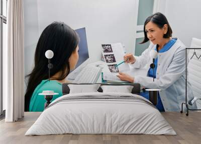 Adult woman getting consultation on her exam results and ovaries ultrasound from her gynecologist. Gynecology and treatment of gynecological diseases Wall mural