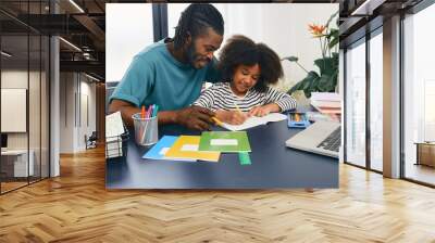 Father helps his daughter doing school homework at home. Father's day, happy dad and schoolgirl, happy family Wall mural