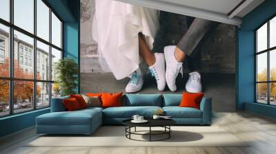 Hipster couple standing together wearing white sneakers. Wedding in sneakers, love. Soft focus tehnic, wedding style clothes Wall mural