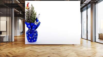 snowy christmas tree in blue festive pot, close-up on white backgraund with space for text. new year Wall mural