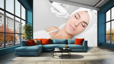 woman receiving no-needle high frequency mesotherapy at beauty salon. non-invasive procedure for skin rejuvenation Wall mural