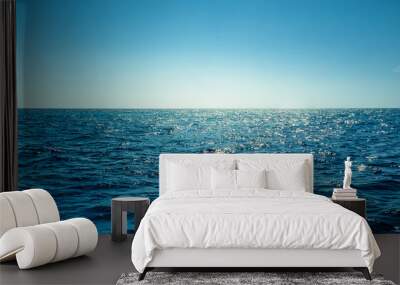 Blue ocean panorama with sun reflection, The vast open sea with clear sky, Ripple wave and calm sea with beautiful sunlight Wall mural