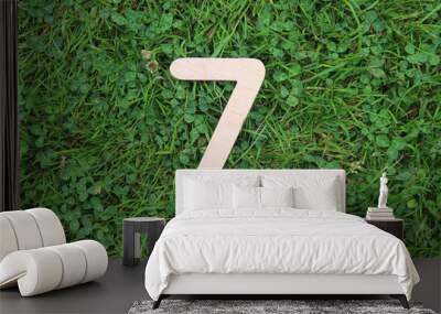 wooden number 7 on grass and clover background Wall mural