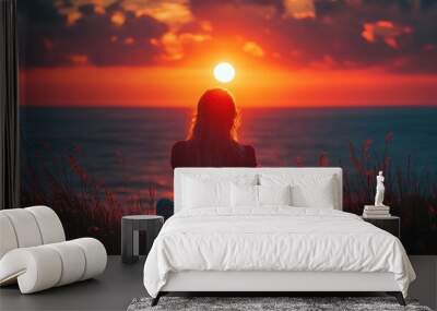 Silhouette of a Woman Watching the Sunset Over the Ocean Wall mural