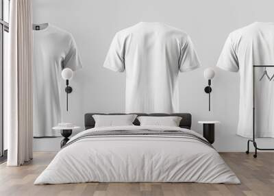 white t-shirts are shown on a white background. The shirts are all the same color and style, with no designs or patterns visible. The shirts are positioned at different angles Wall mural