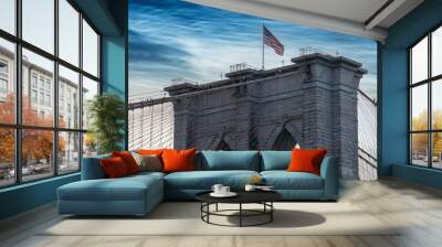 Brooklyn Bridge spans the East River with clear blue skies and city skyline in the background during a bright sunny day in New York City Wall mural