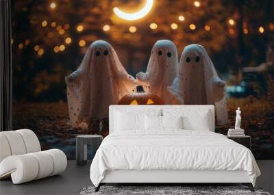 Little kids dressed as ghosts and pumpkins, standing under a soft crescent moon Wall mural