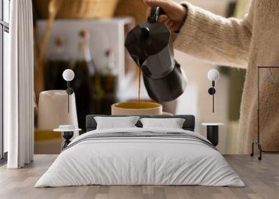 Hand of a woman pouring coffee with an italian coffee maker in a kitchen Wall mural