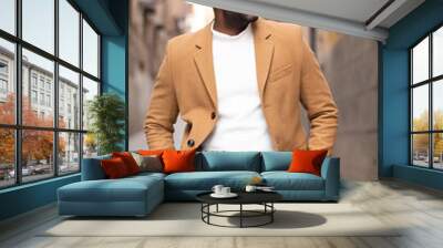 Handsome and stylish african american walking and looking aside while he is smiling on a street. Wall mural