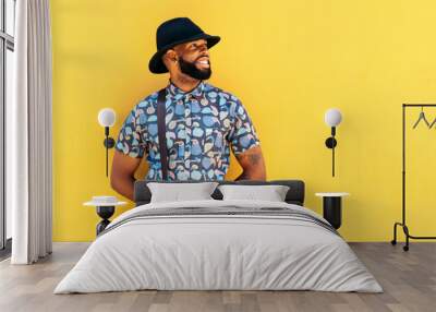 Stylish black man outdoors over yellow background Wall mural