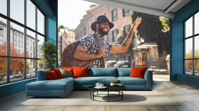 Stylish black man walking on the city street Wall mural