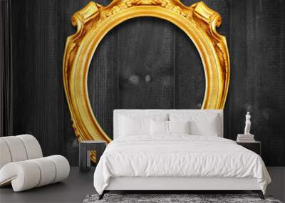 The Antique gold frame on wooden wall;. Empty Antique gold picture frame on wooden wall. Wall mural