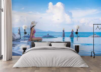 Asian traveler bikini woman relax and travel in infinity pool resort at Koh Samui beach Thailand Wall mural