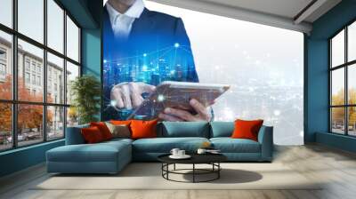 Double exposure business man using tablet on futuristic network connect city technology background Wall mural