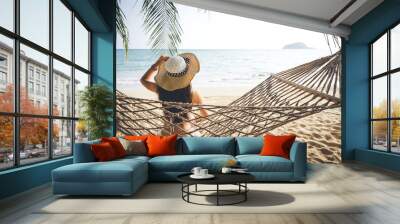 Happy woman relaxing in hammock Wall mural